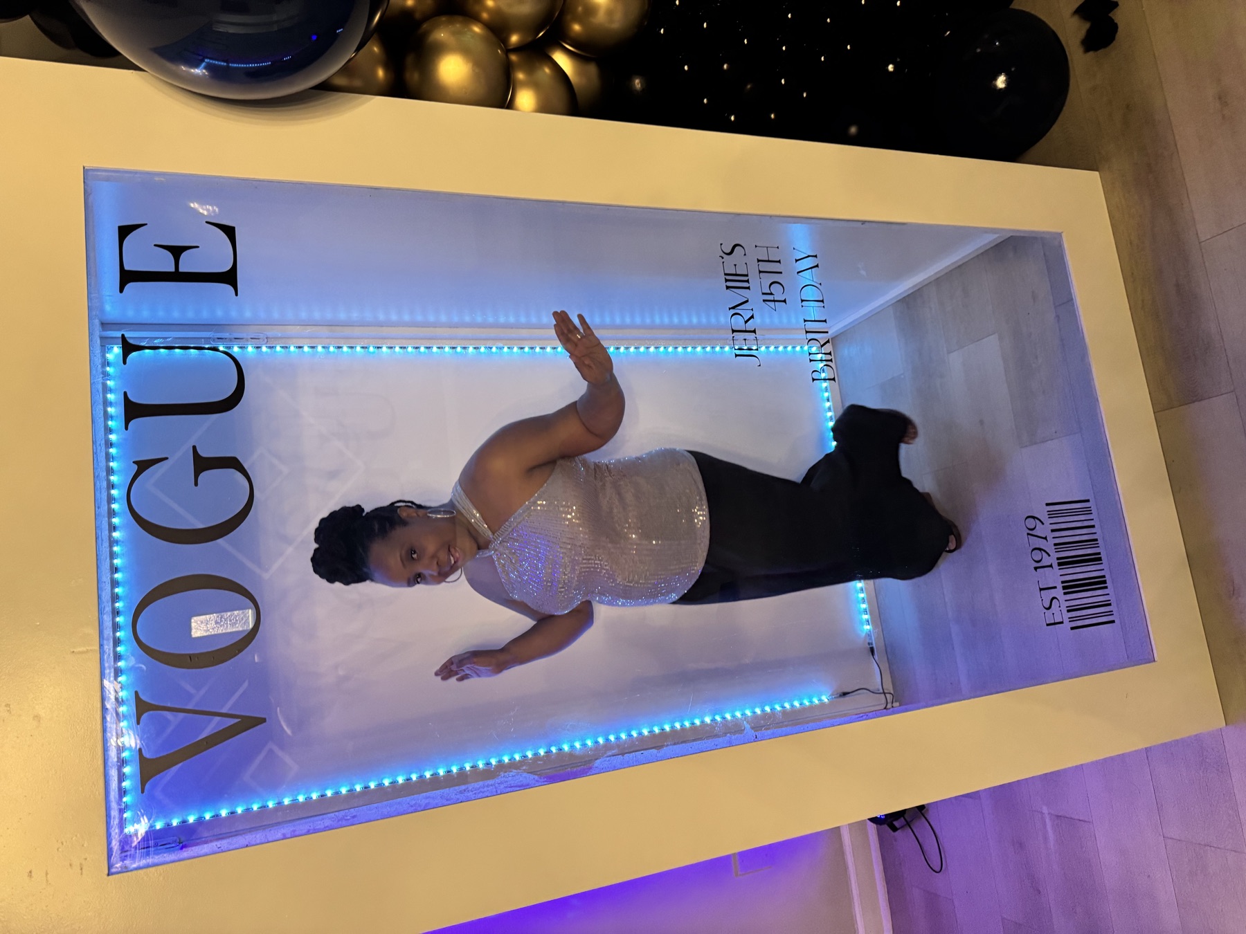 Beatrice posing in a birthday photo booth